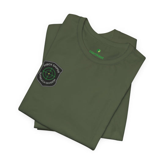 Folded green t-shirt with a patch and logo on a white background